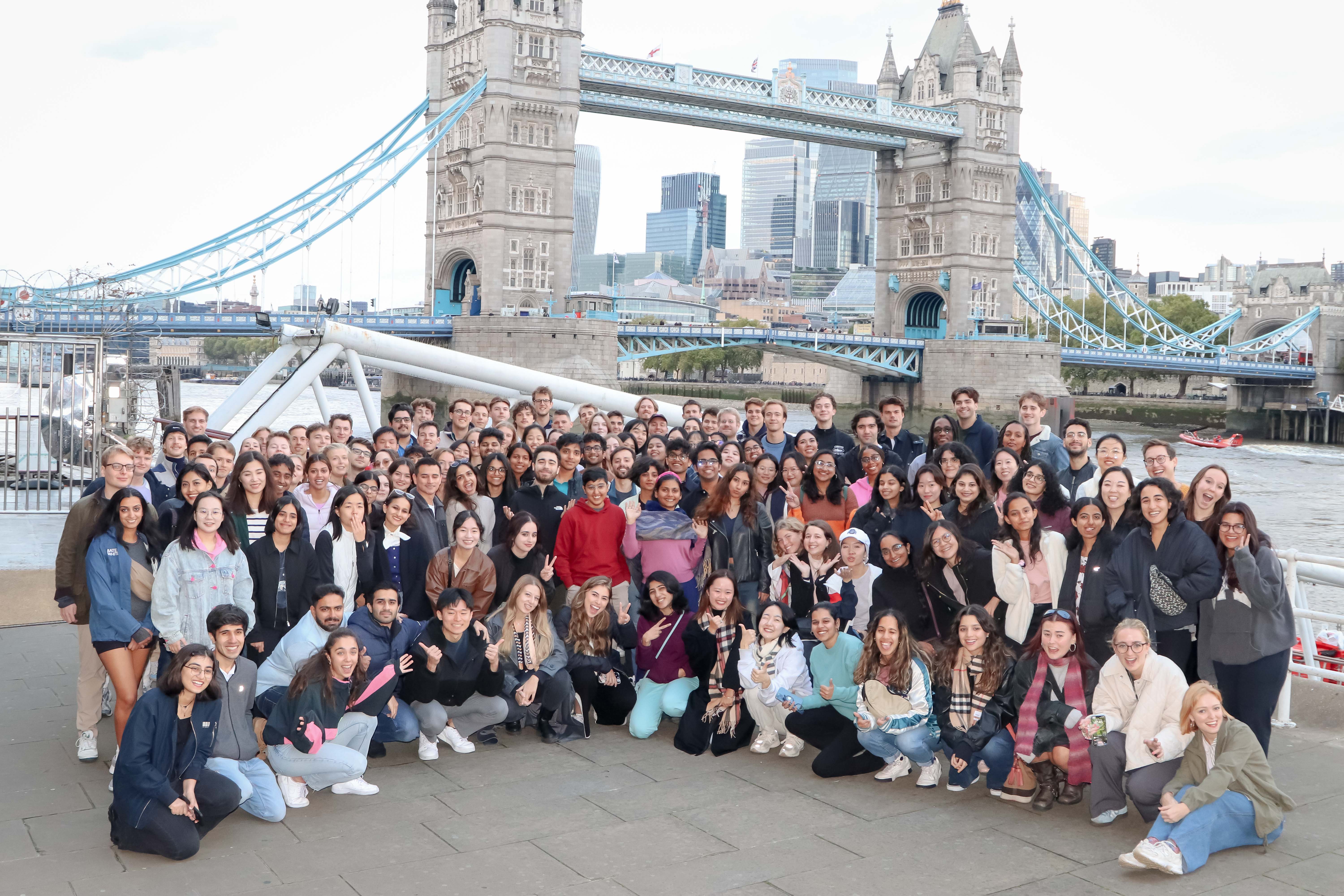 a group of people standing in front of a crowd posing for the camera
