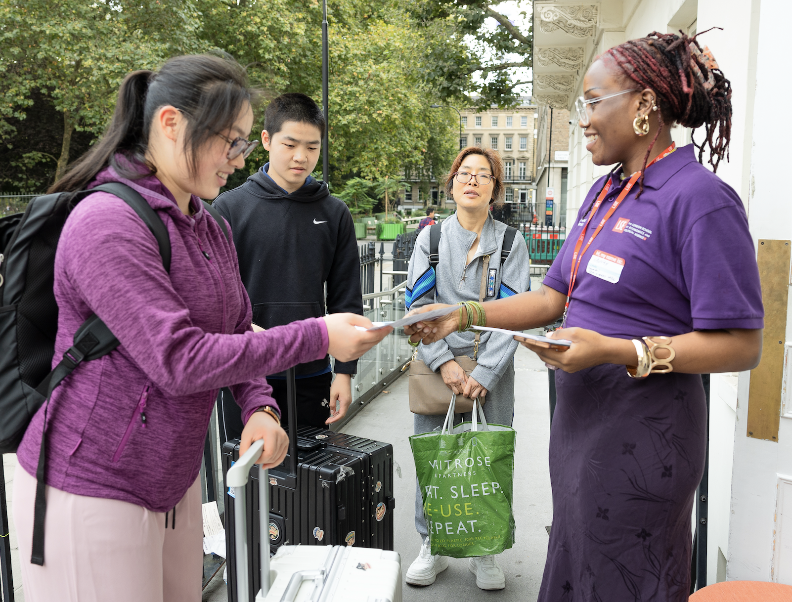 a group of people standing with luggage