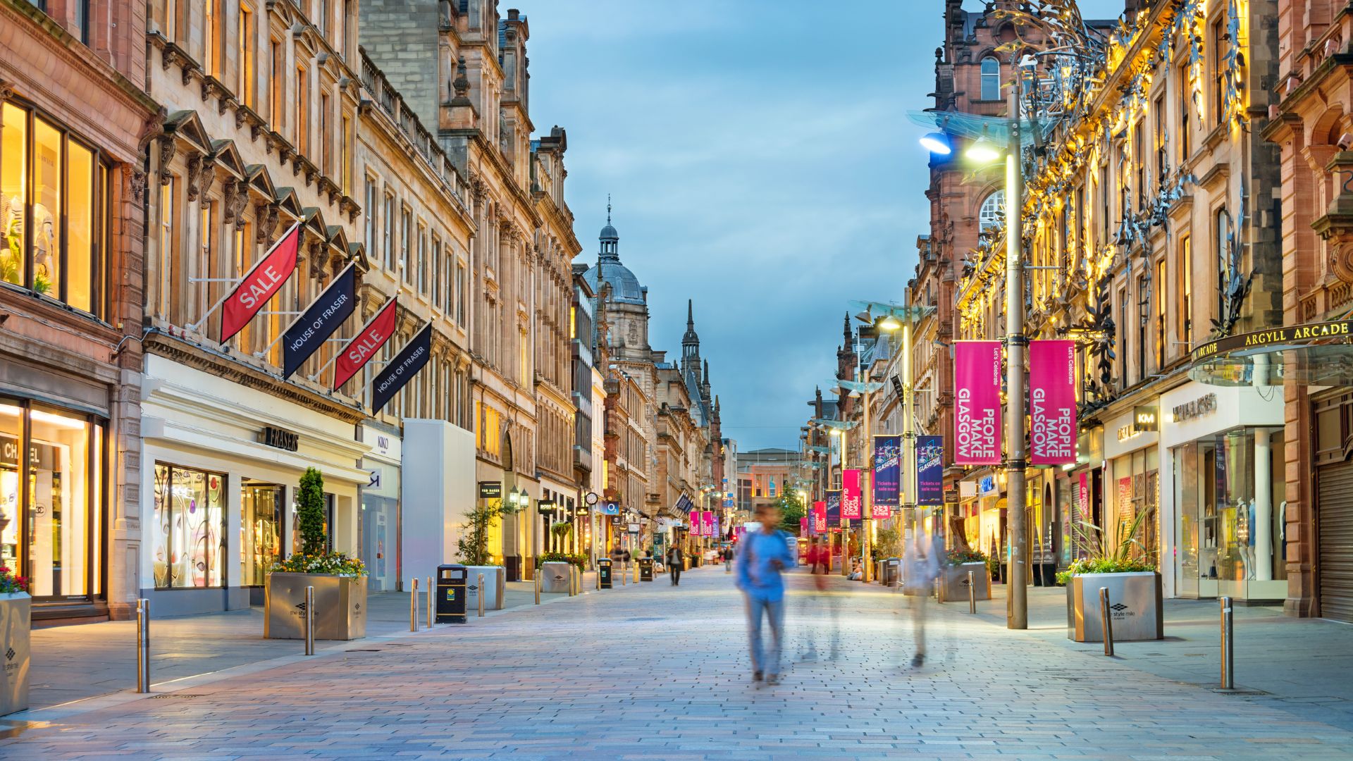 a group of people walking on a city street