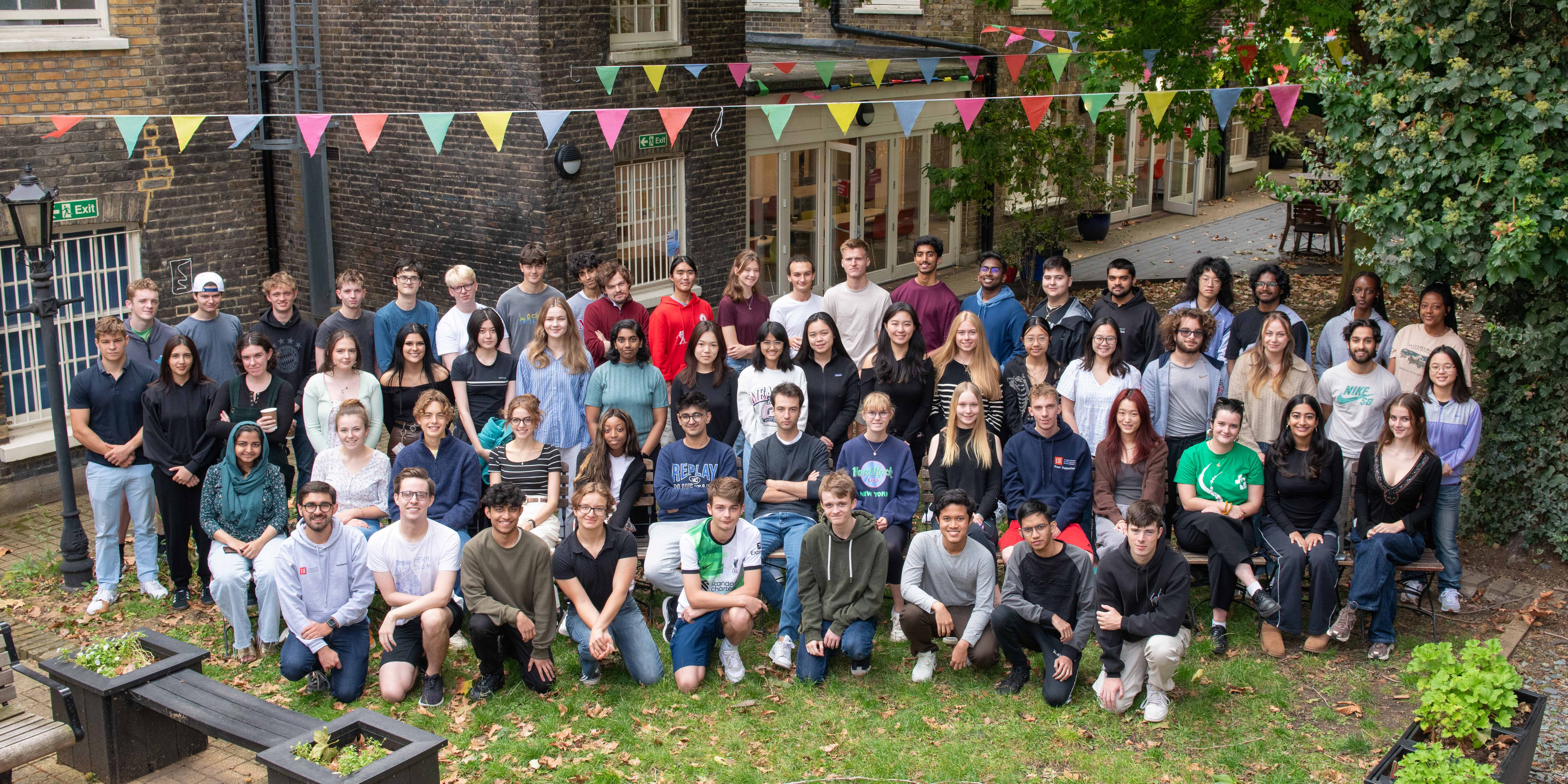 a group of people standing in front of a crowd posing for the camera