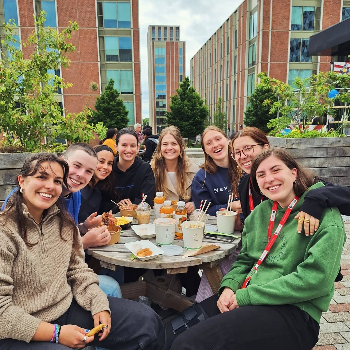 a group of people sitting at a table posing for the camera