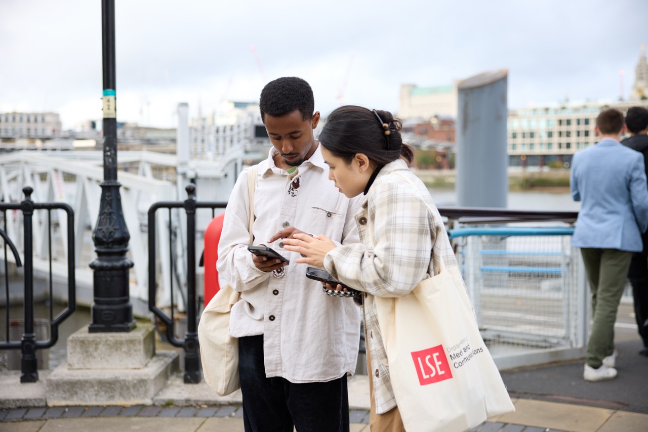 two students looking at a phone