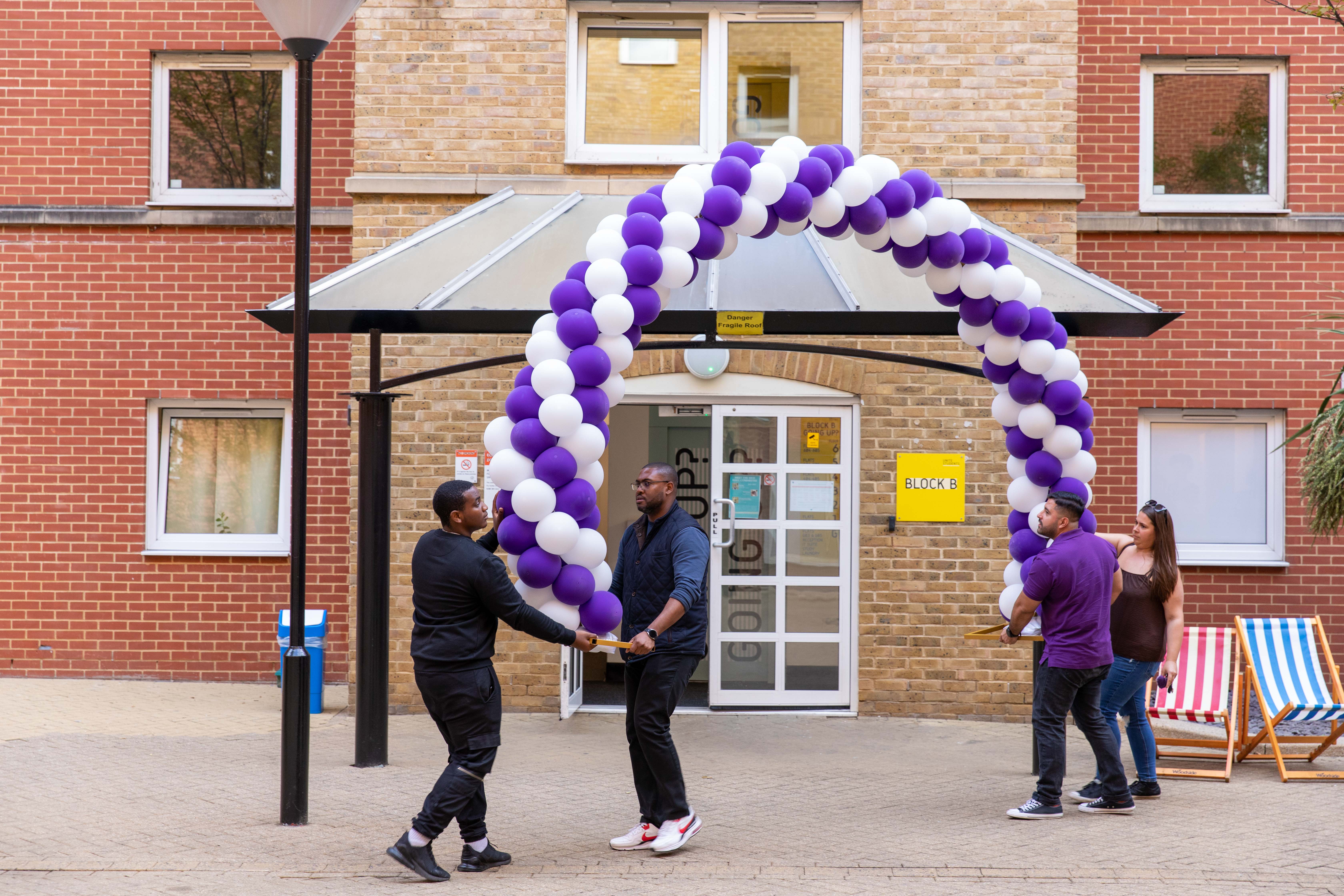 a person standing in front of a brick building