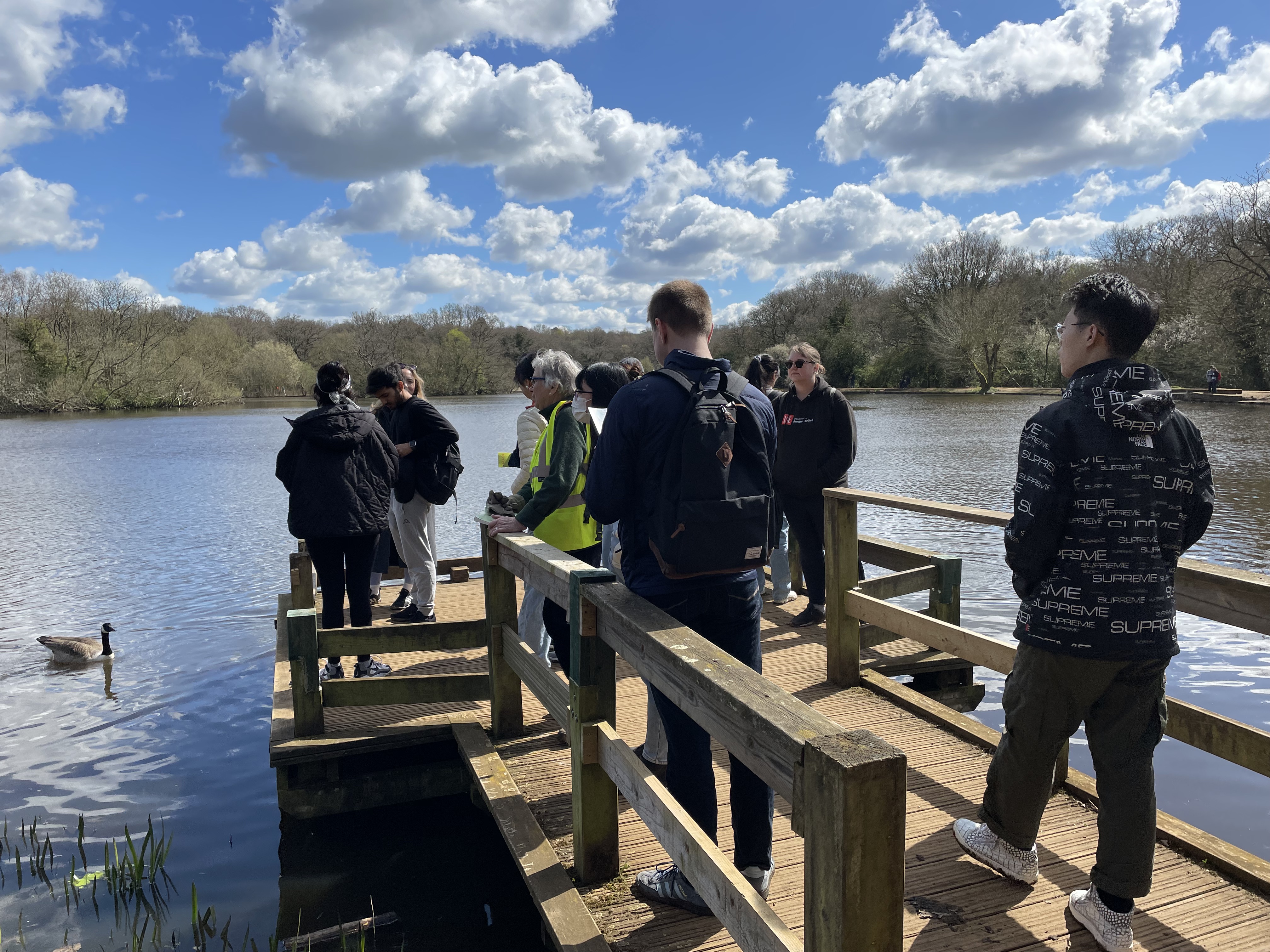 a group of people standing next to a body of water