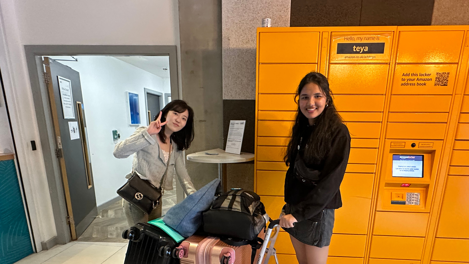 two students with their luggage on move-in weekend.