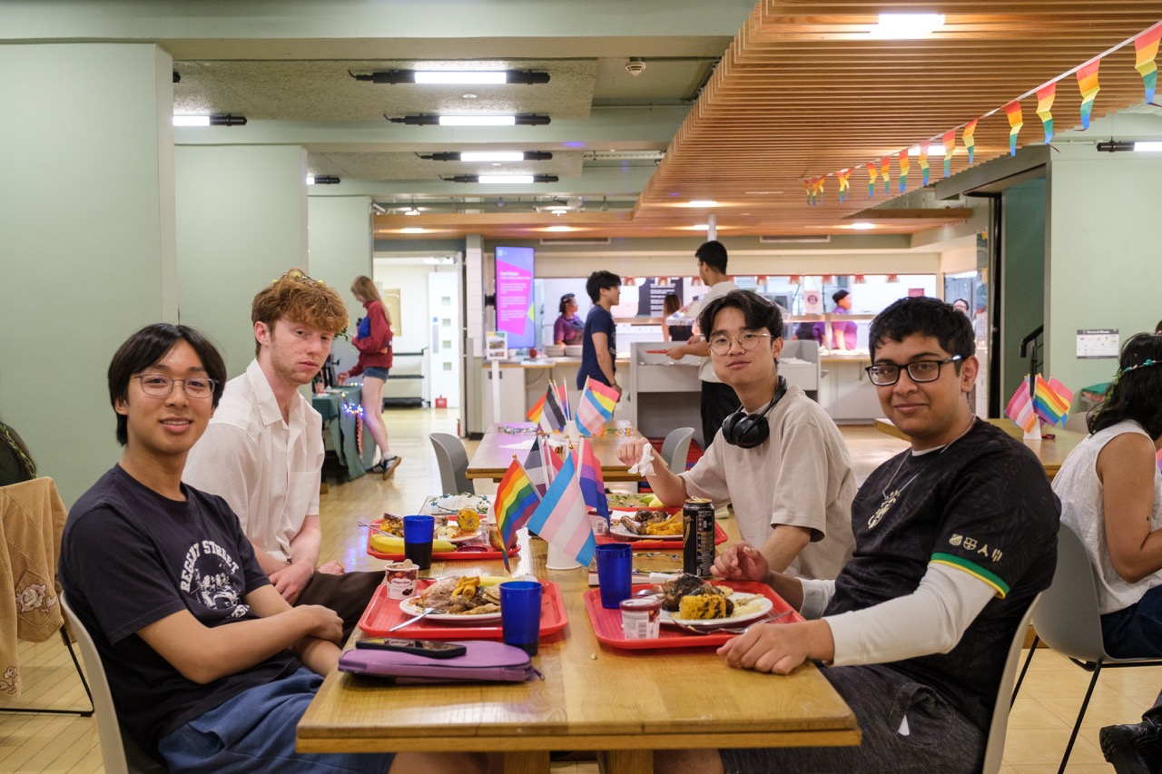 a group of people preparing food in a kitchen
