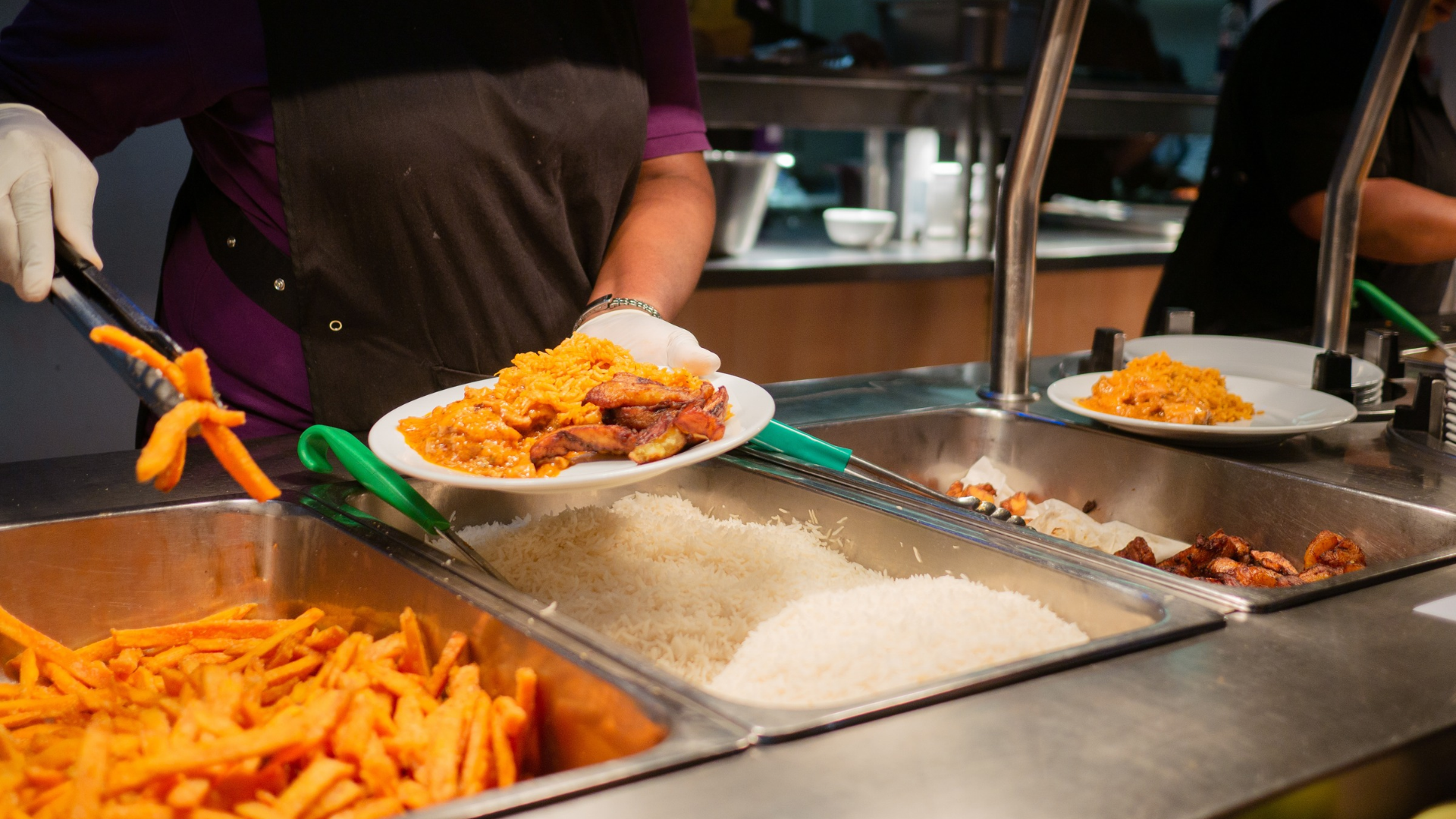 a person serving food in catered halls