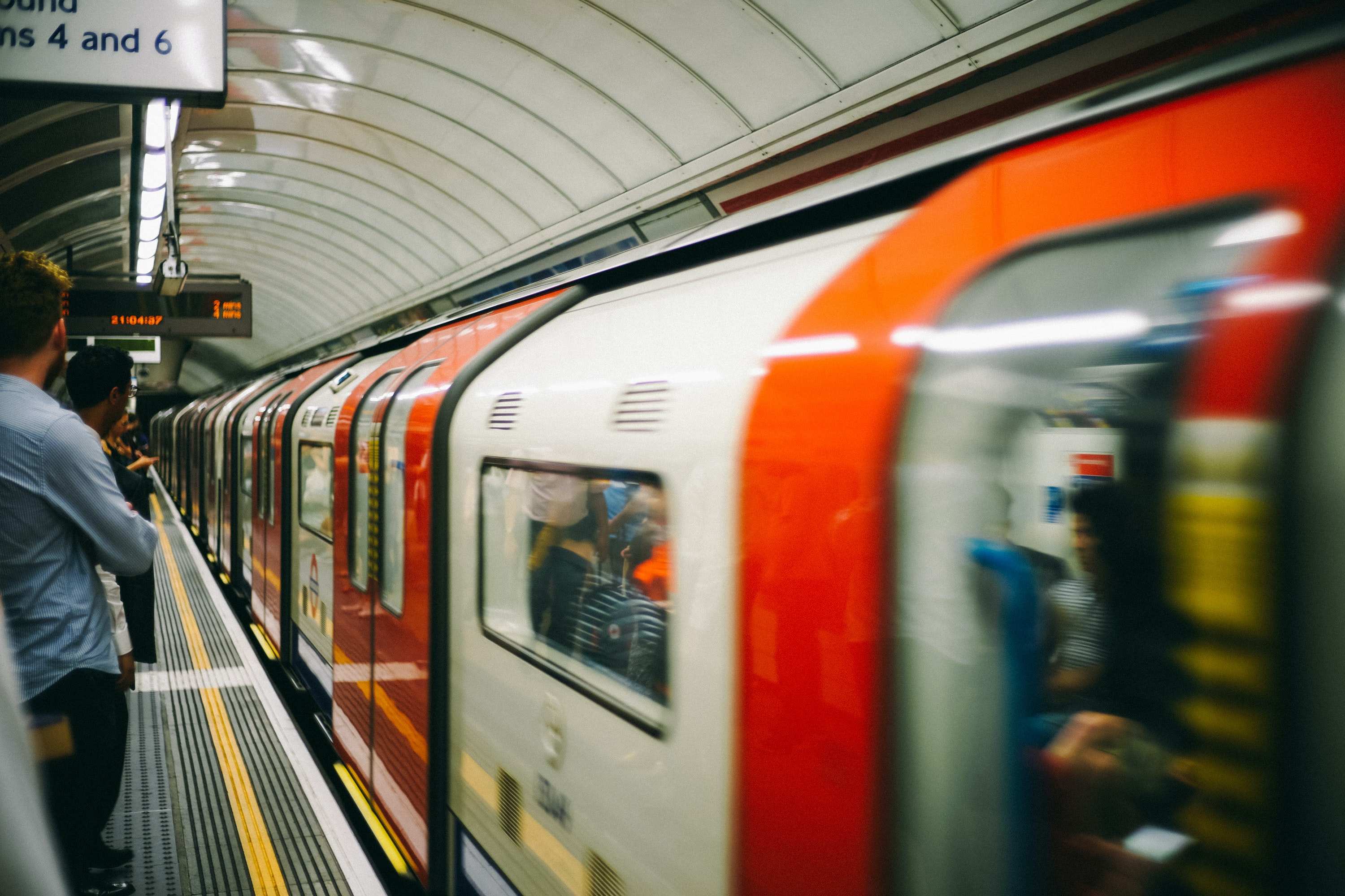 a person standing on a subway train at a train station