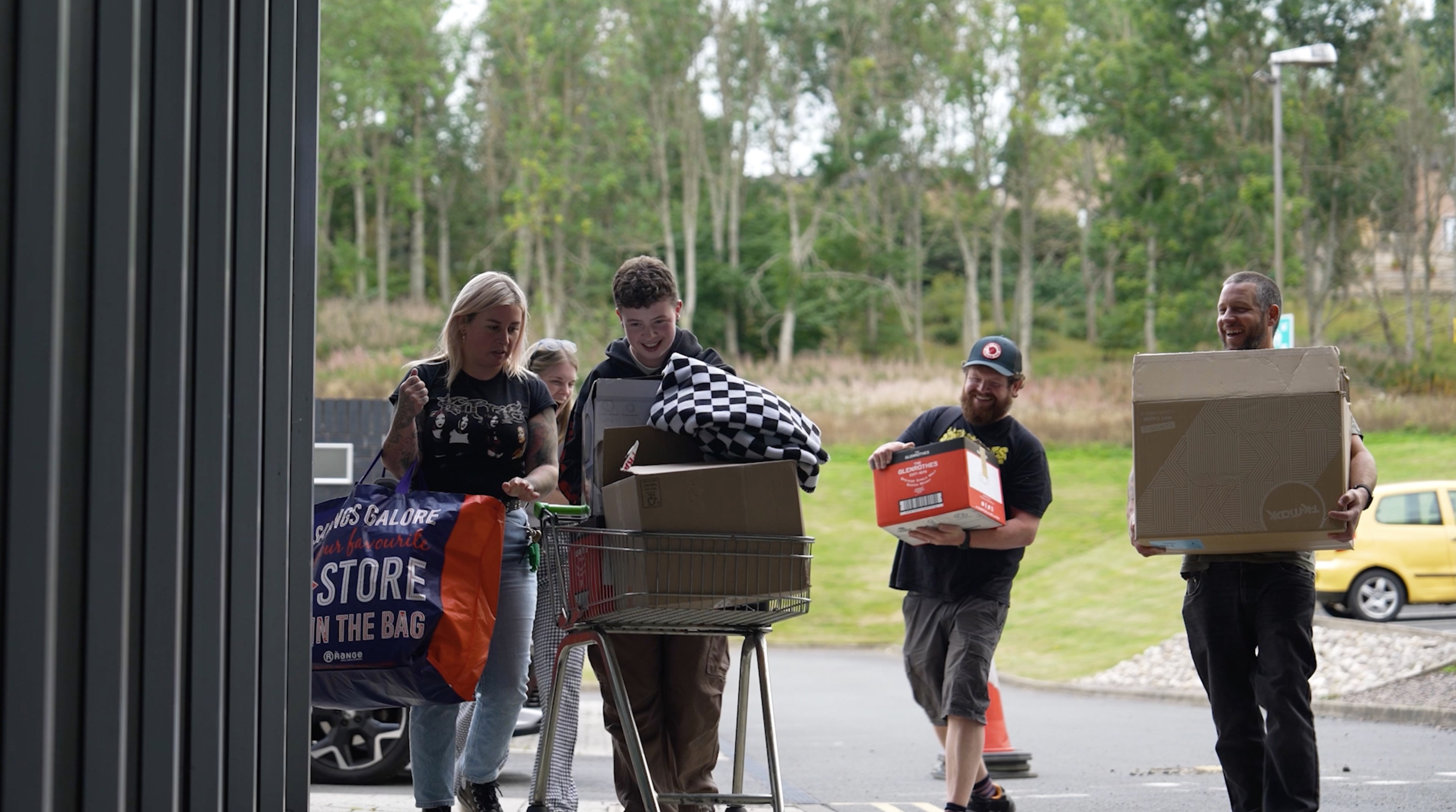 a group of people on a sidewalk moving into accommodation