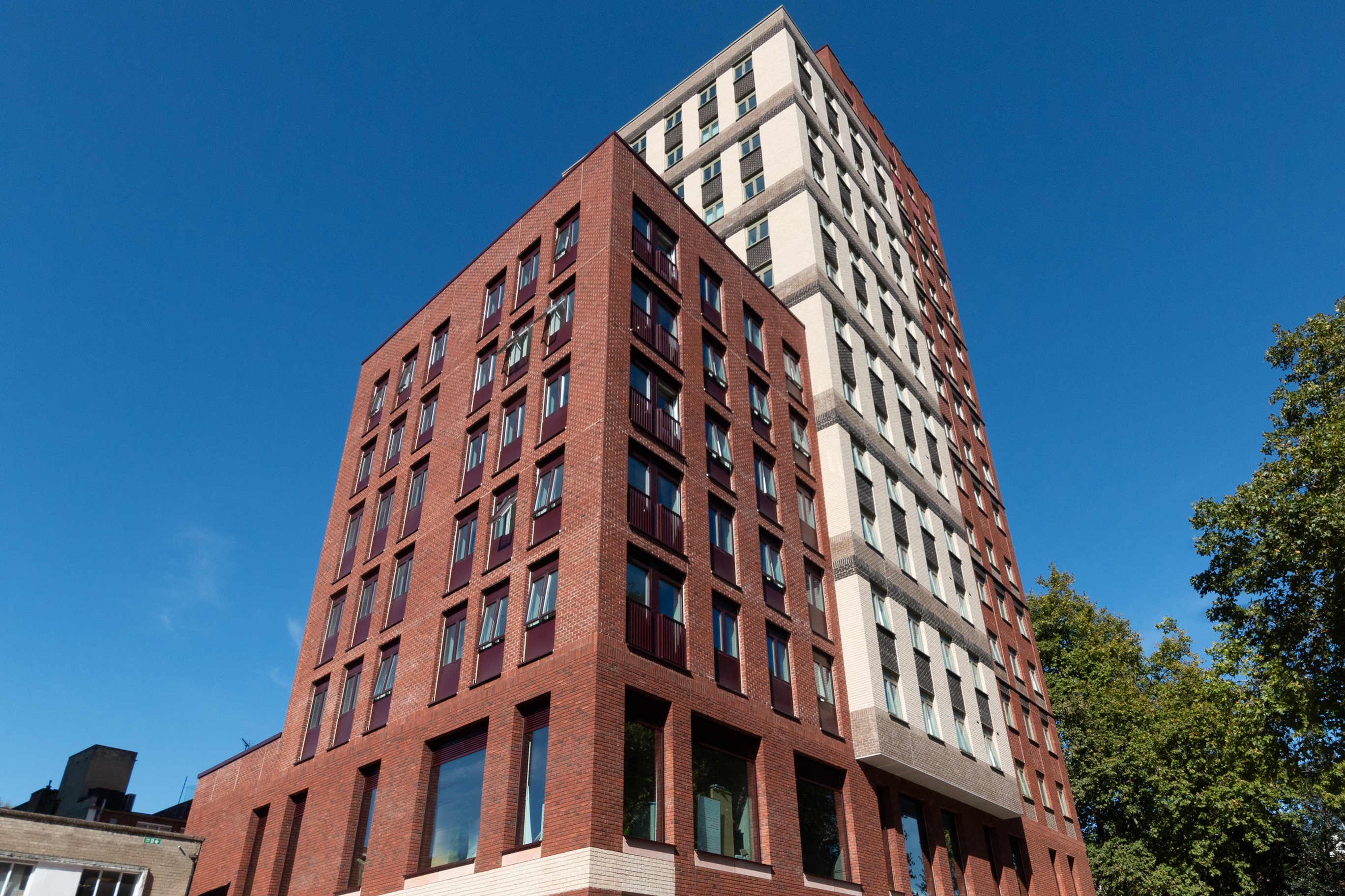 a large tall tower with a clock on the side of a building