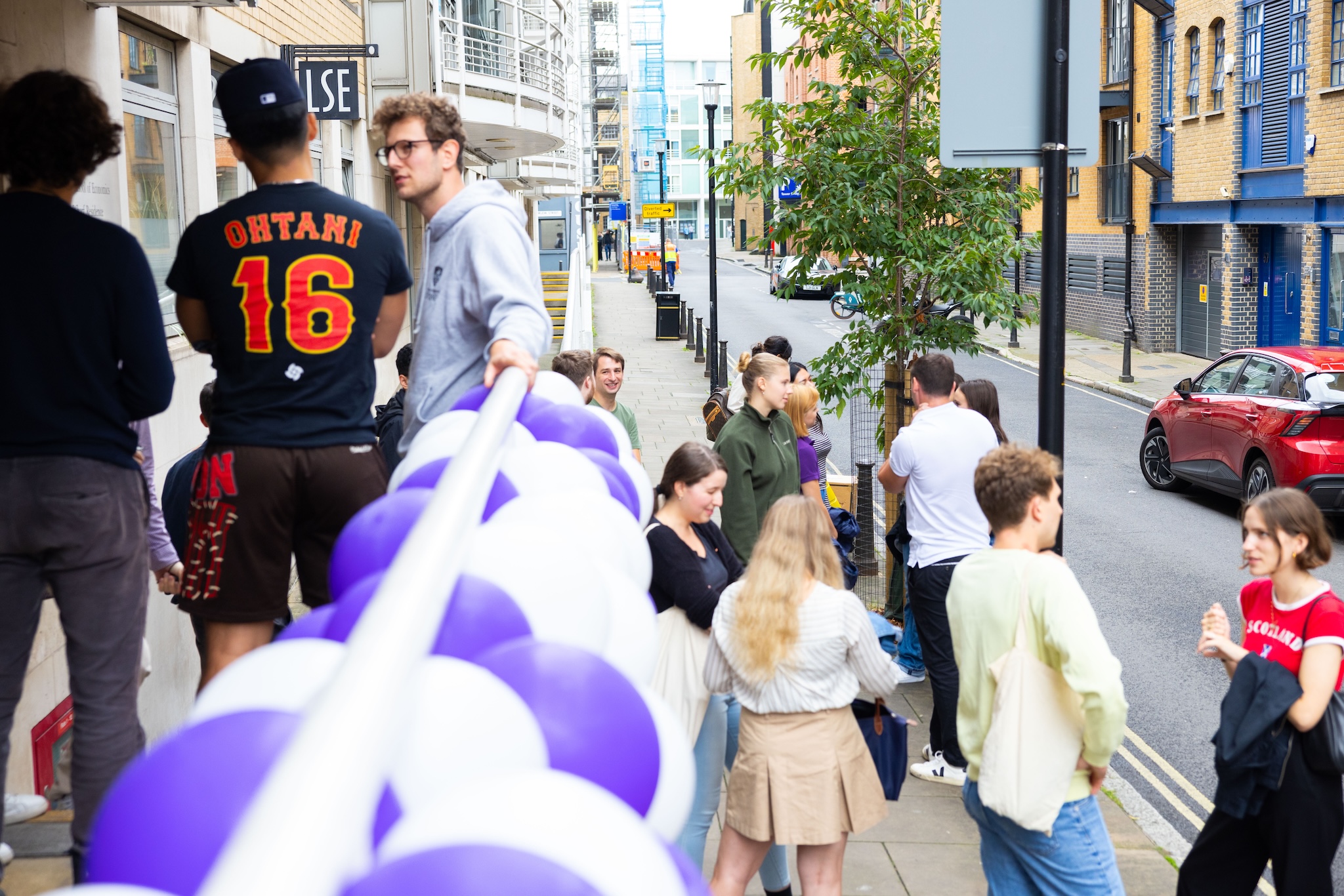 a group of people walking down the street