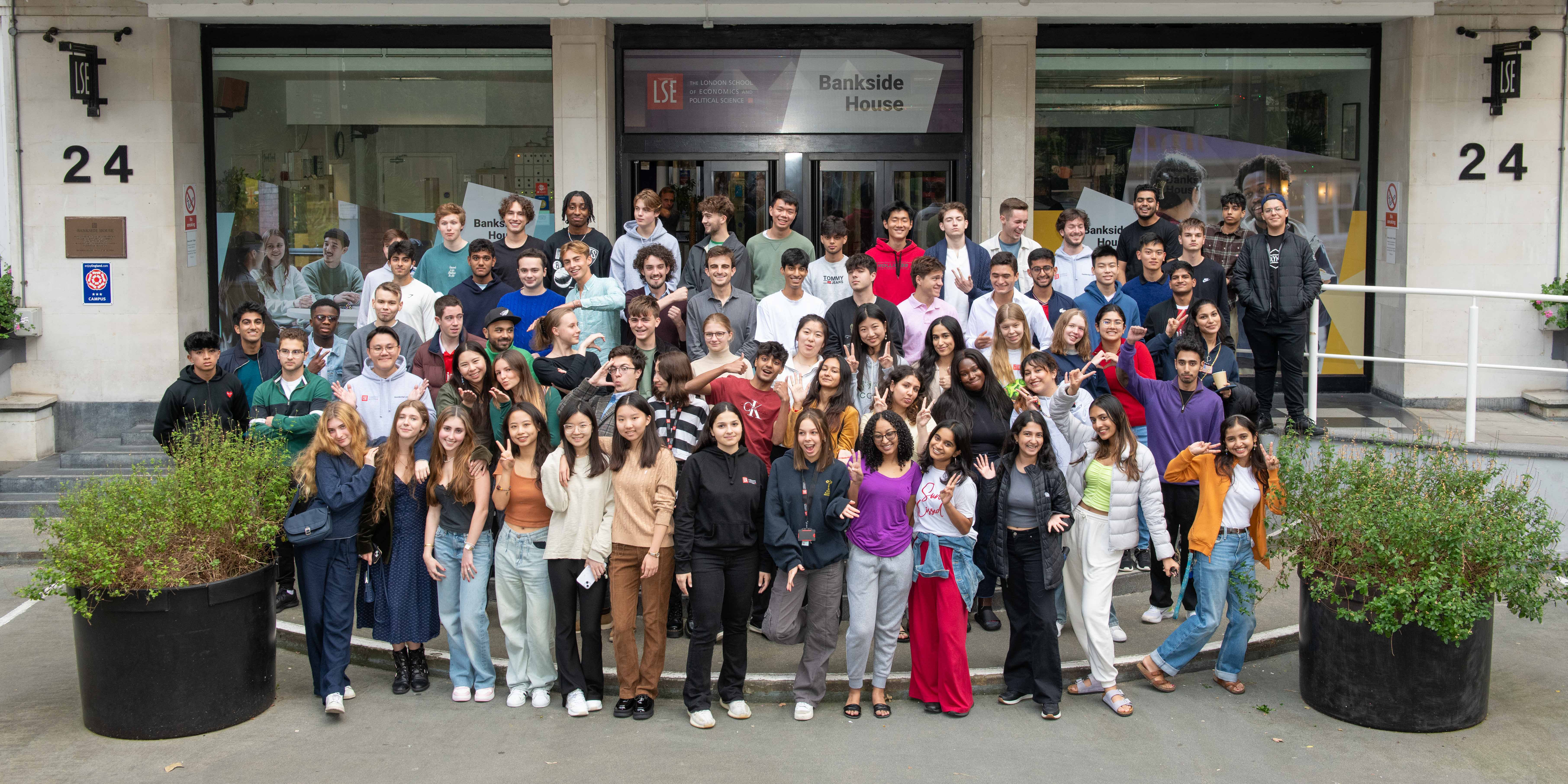 a group of people standing in front of a crowd posing for the camera