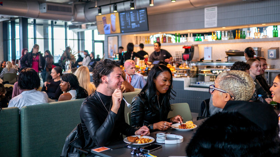 a group of people sitting at a table in a restaurant