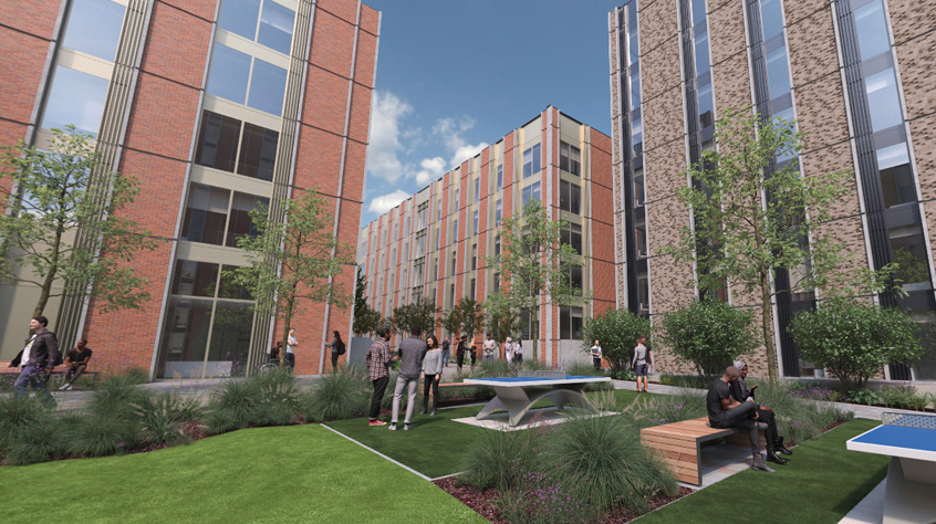 a large brick building with grass and trees