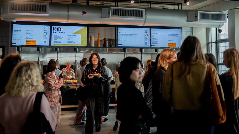 a group of people standing in a canteen