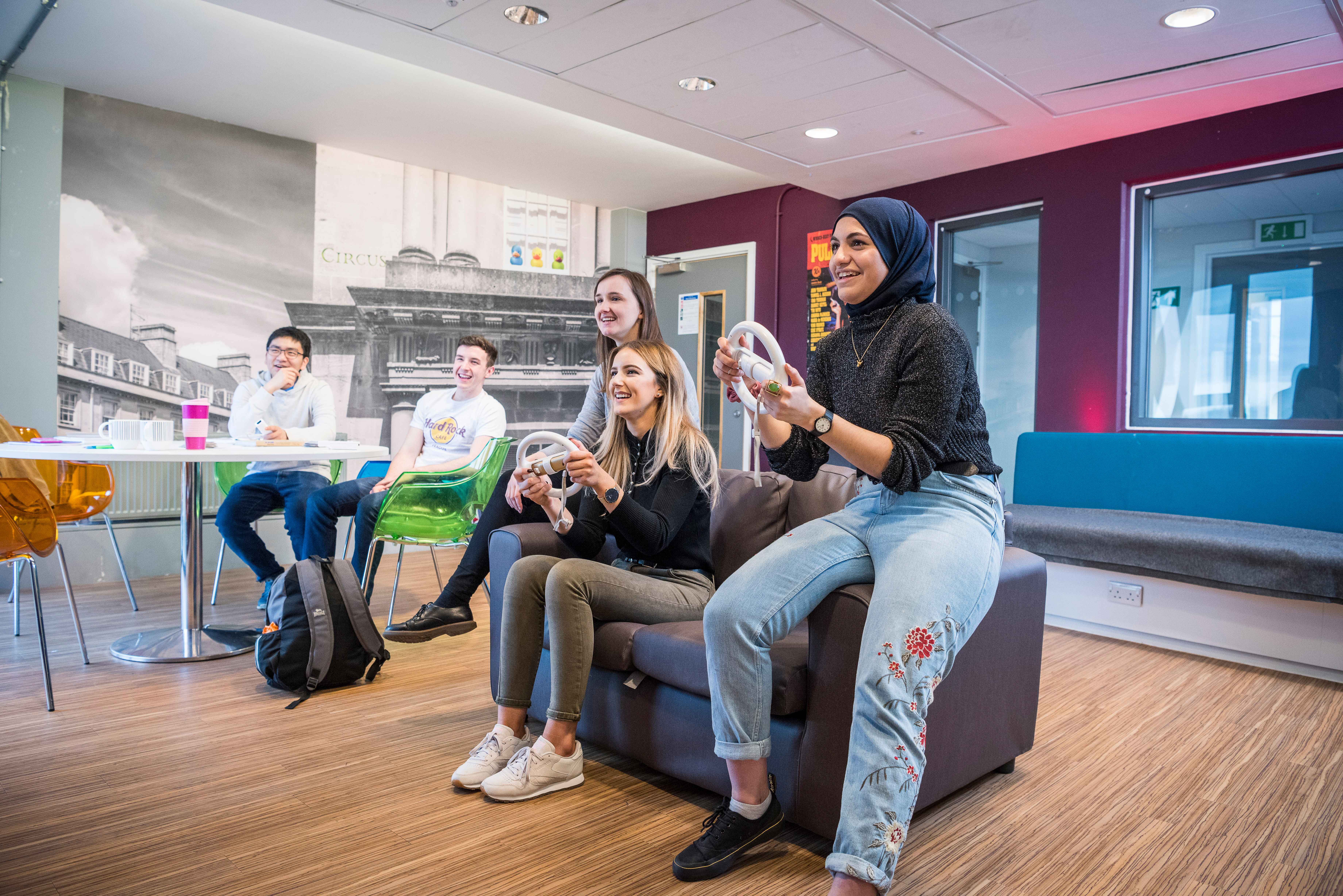 people playing on a Wii console in Quads social space with closed door