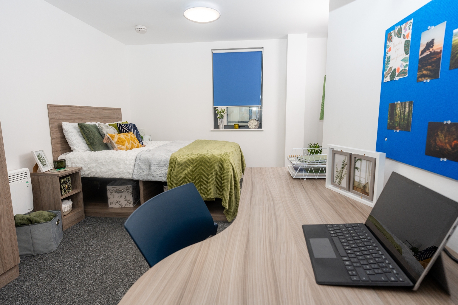 a double en-suite room at Grafton Street with the bed, desk, shelves and bedside tables visible.