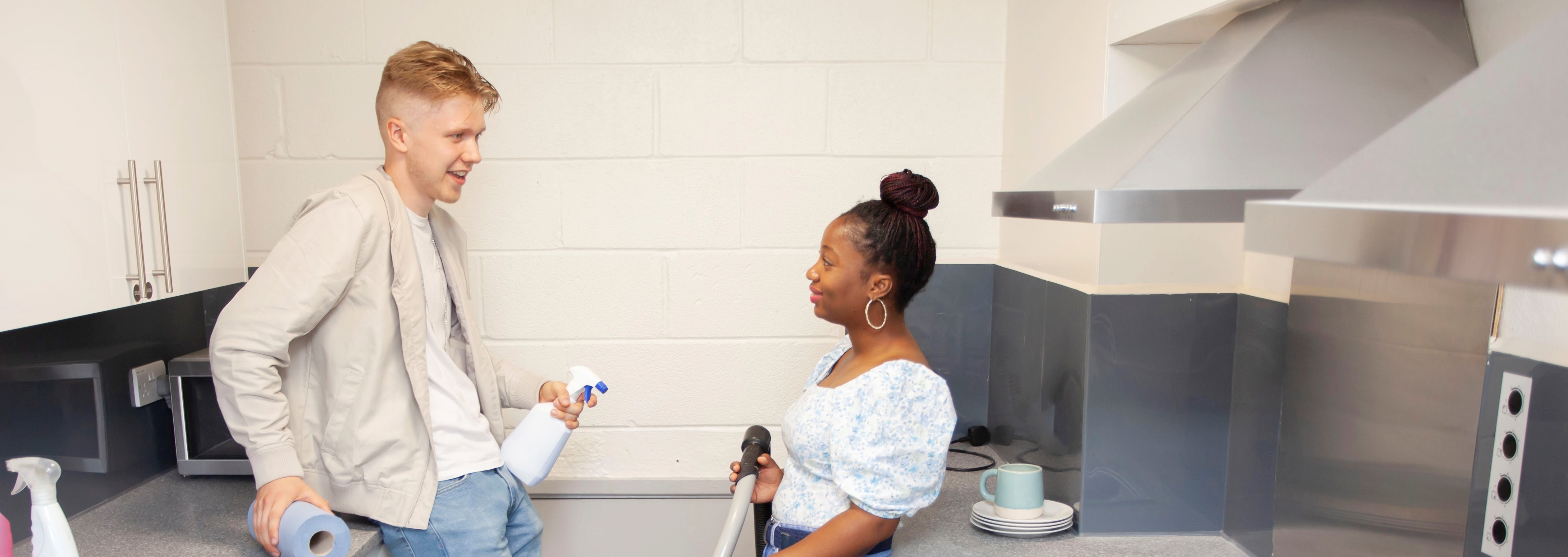 a person sitting on a table with a vacuum cleaner