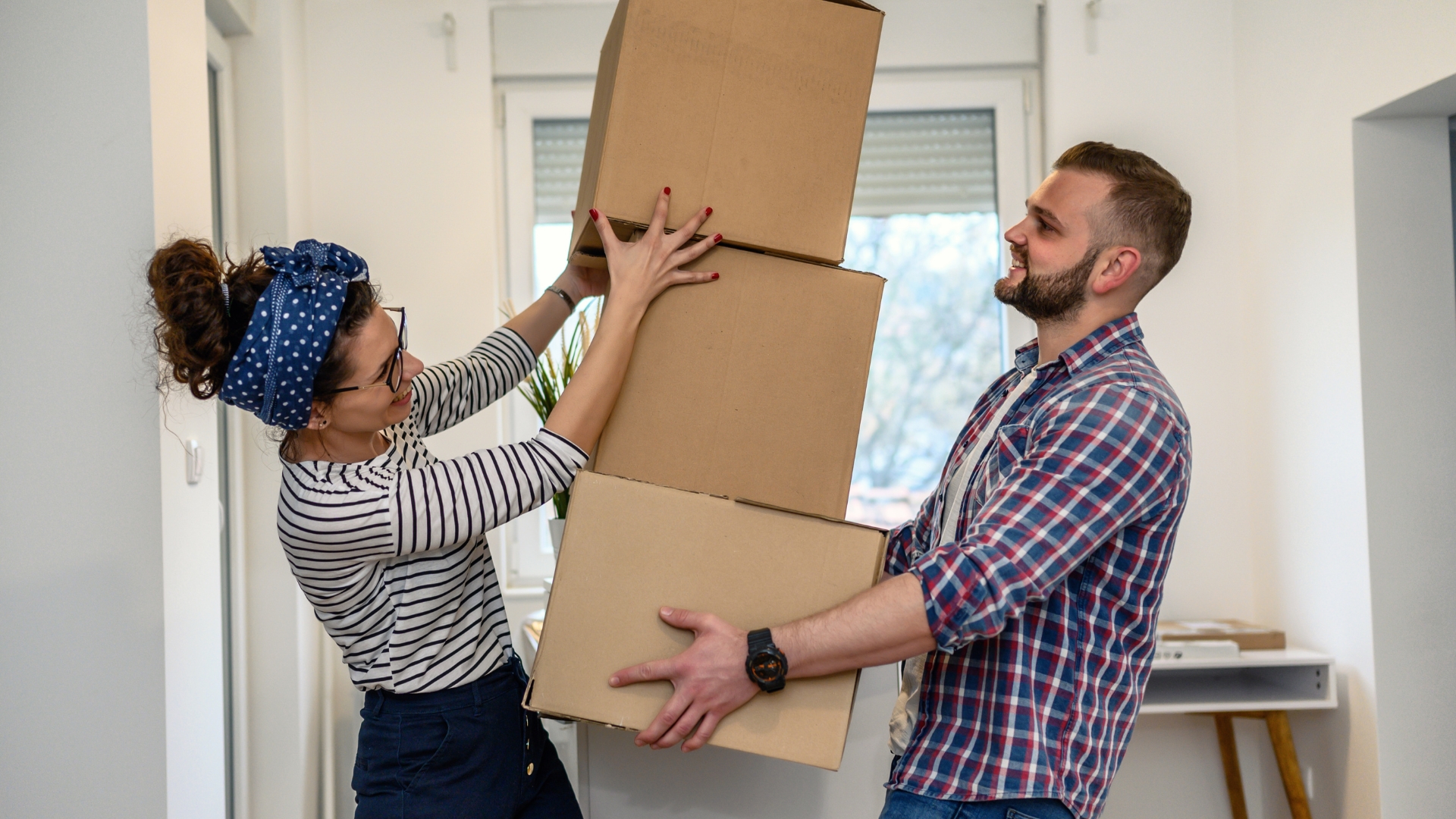 a man and a woman balancing boxes