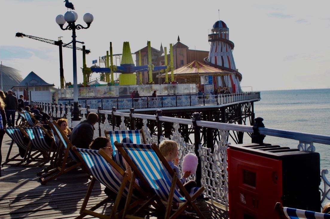 a group of people sitting at a dock
