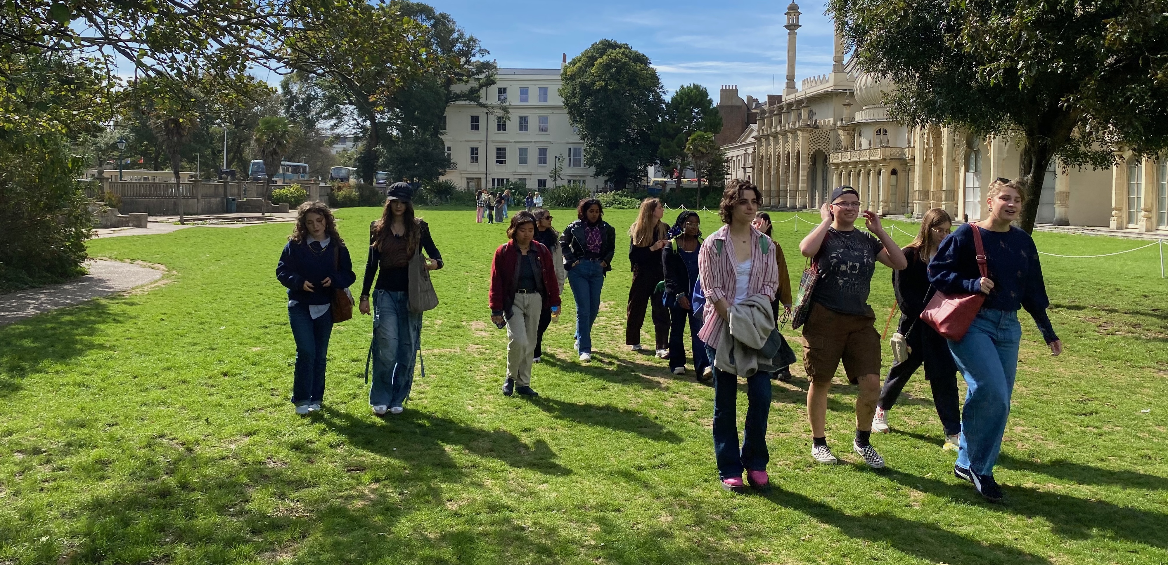 a group of people that are standing in the grass
