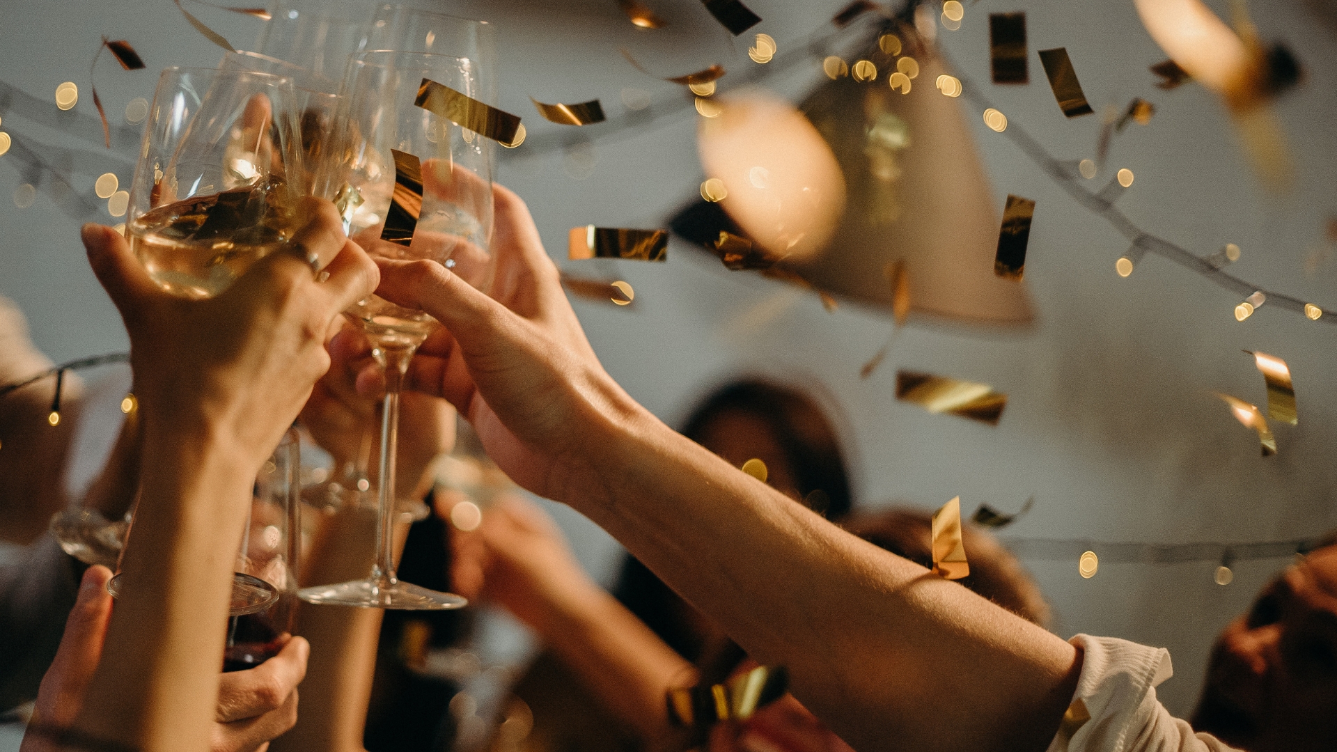 a hand holding a glass of wine