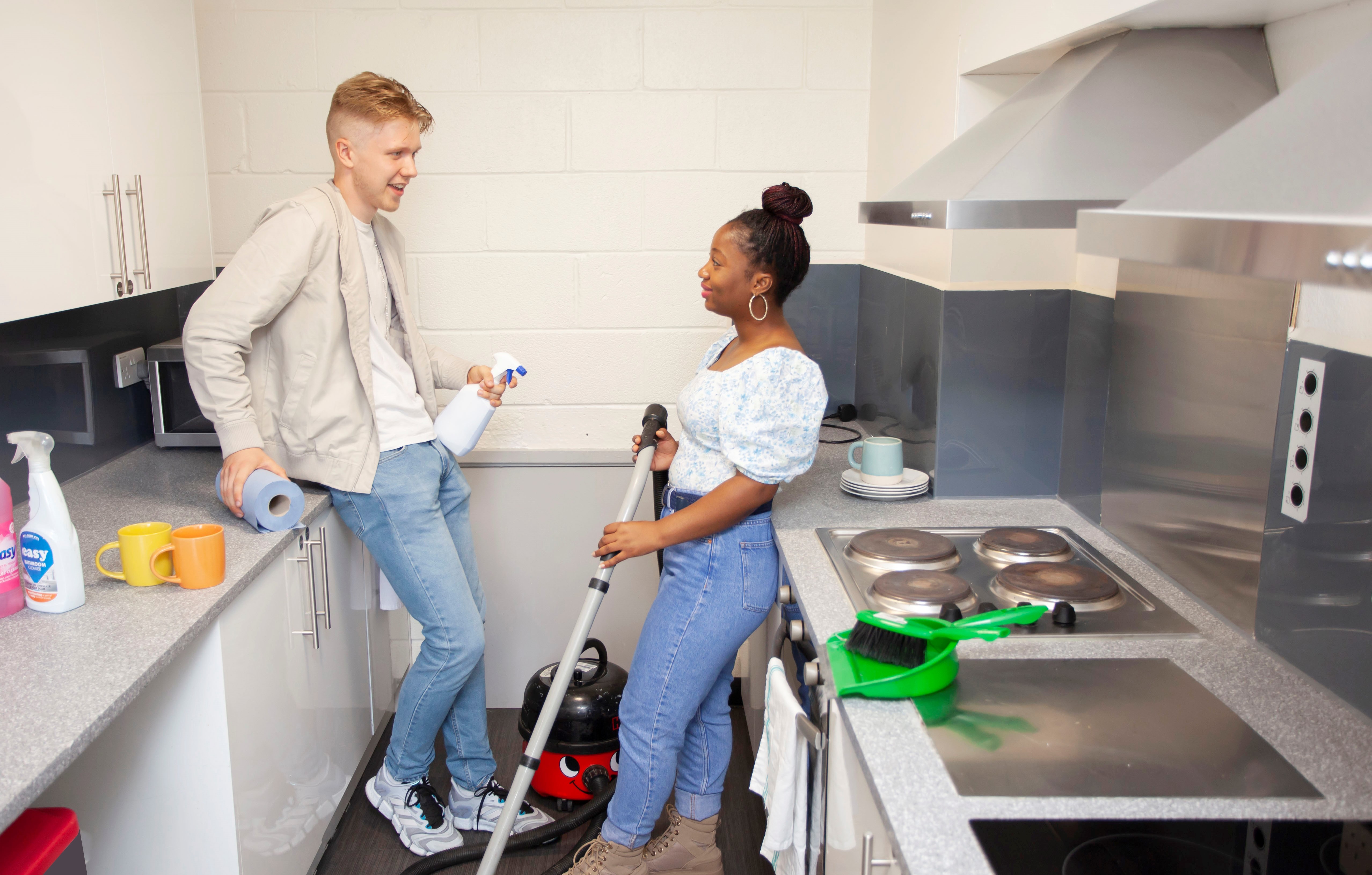 Students cleaning and interacting in the kitchen