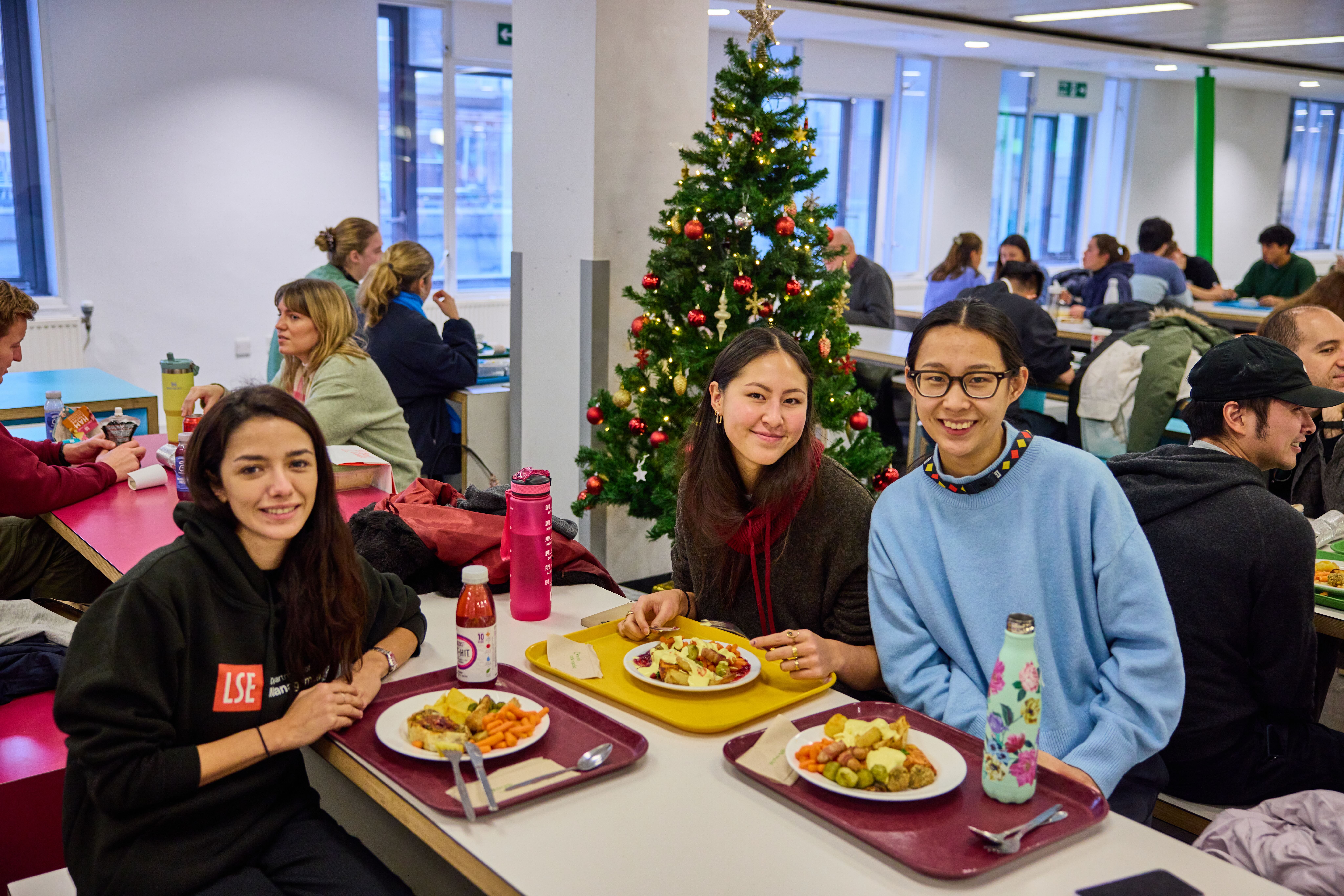 a group of people sitting at a table eating food